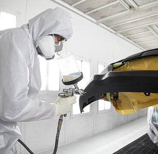 Collision Center Technician Painting a Vehicle | Dalton Toyota National City in National City CA