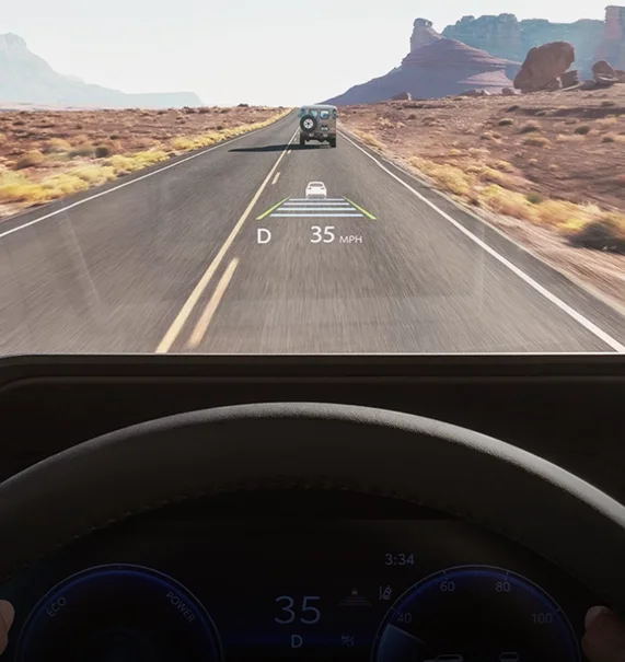 Head-Up Display projecting vehicle speed onto the windshield on a desert highway