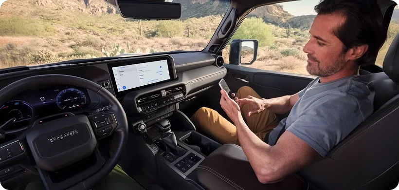 Passengers using connected devices inside the Land Cruiser