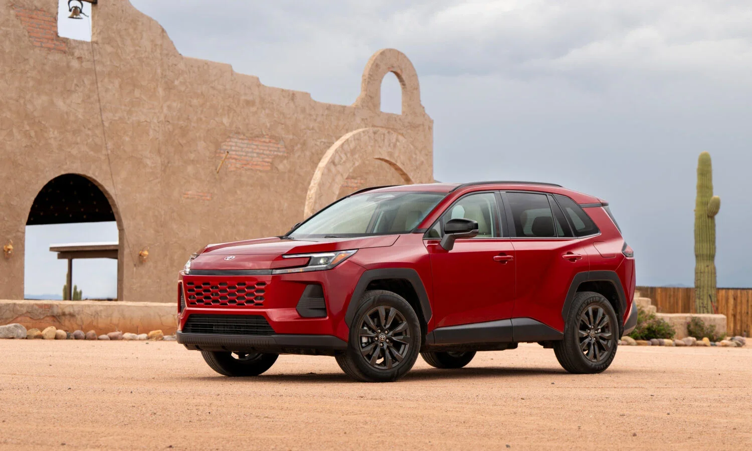 2026 Toyota RAV4 XLE in Ruby Flare Pearl red, front three-quarter view in the desert — Dalton Toyota National City