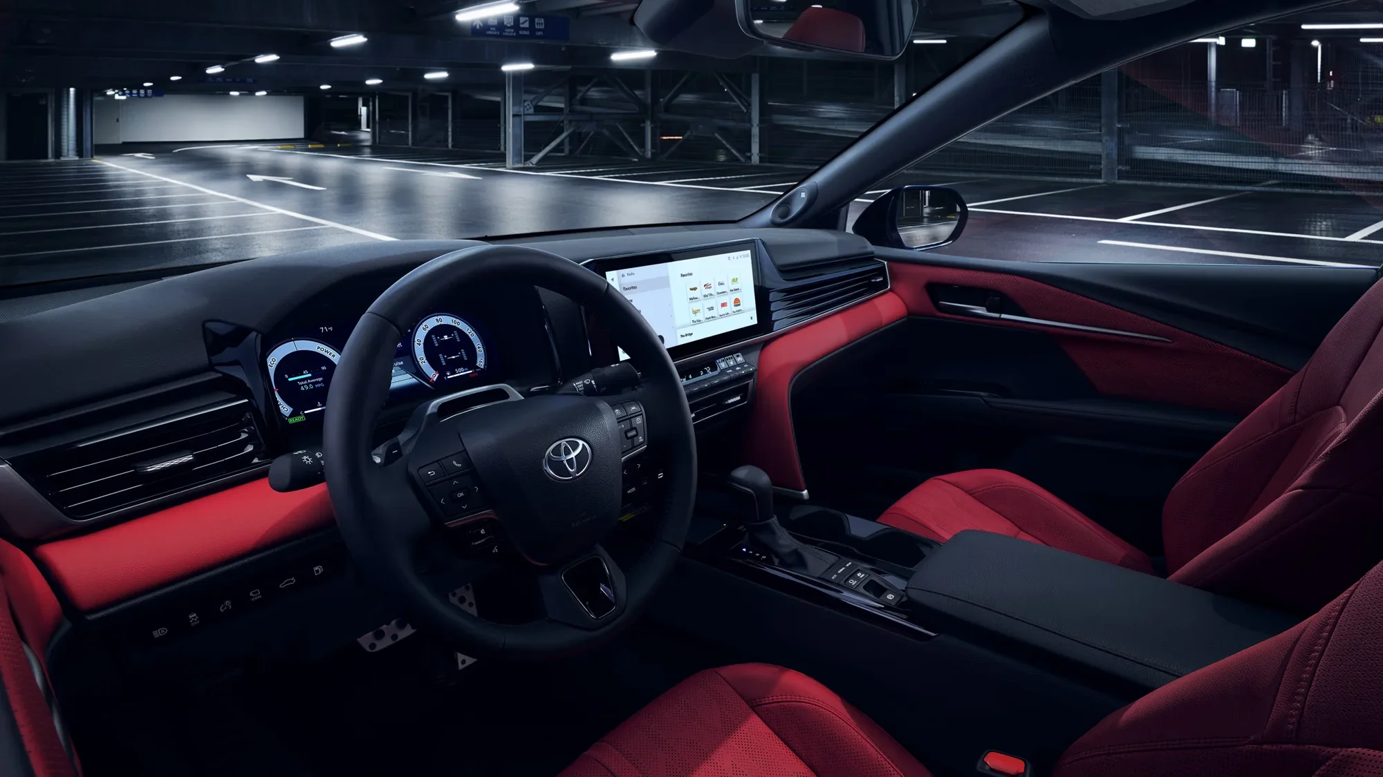 The Camry dashboard and touchscreen with red leather seats