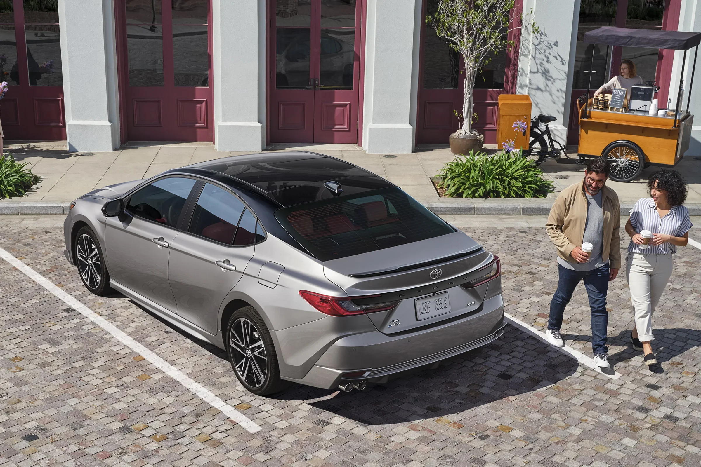 A silver Toyota Camry parked on a city street, seen from above