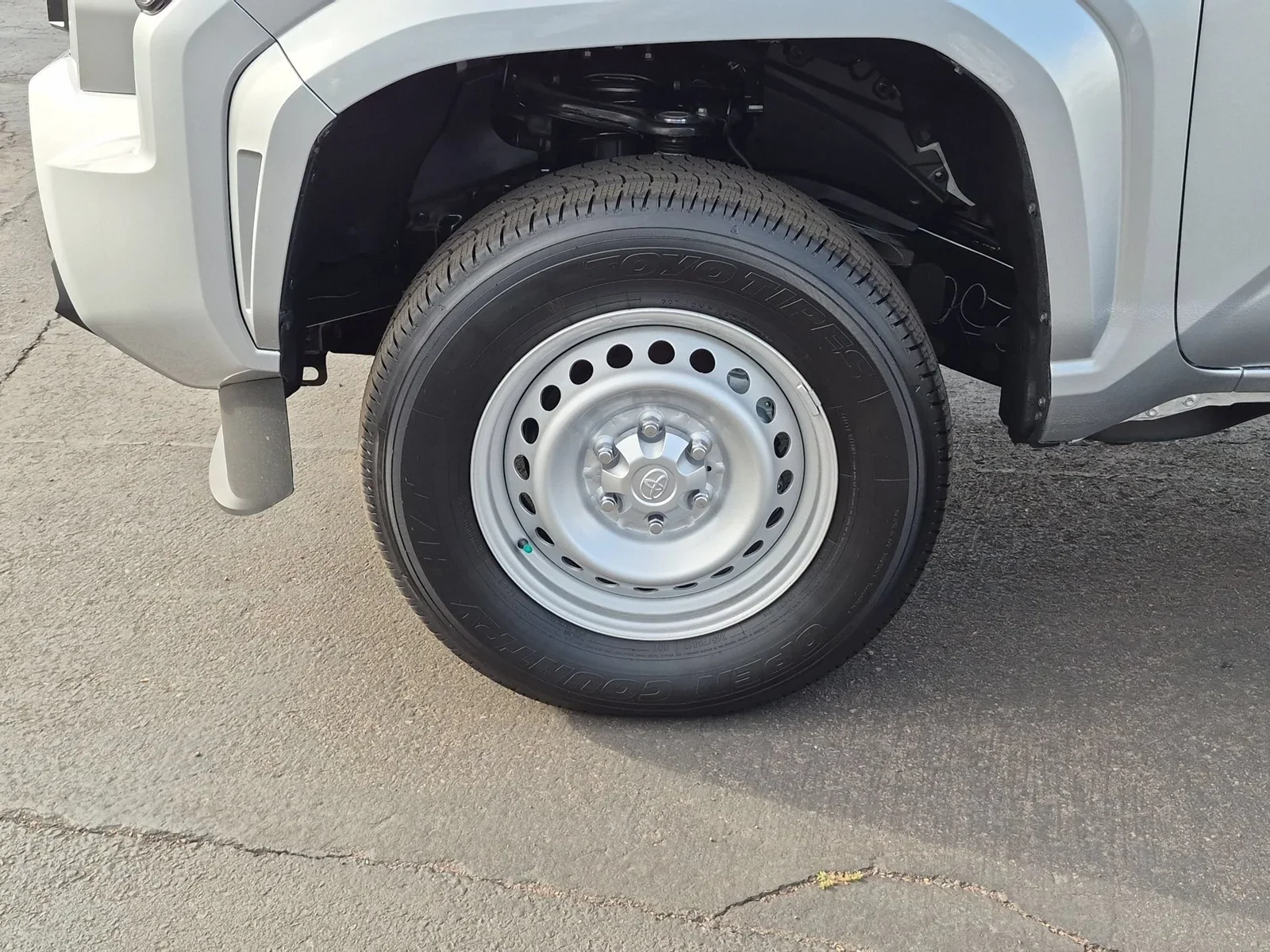 Close-up of a steel wheel and all-season tire on a Toyota Tacoma