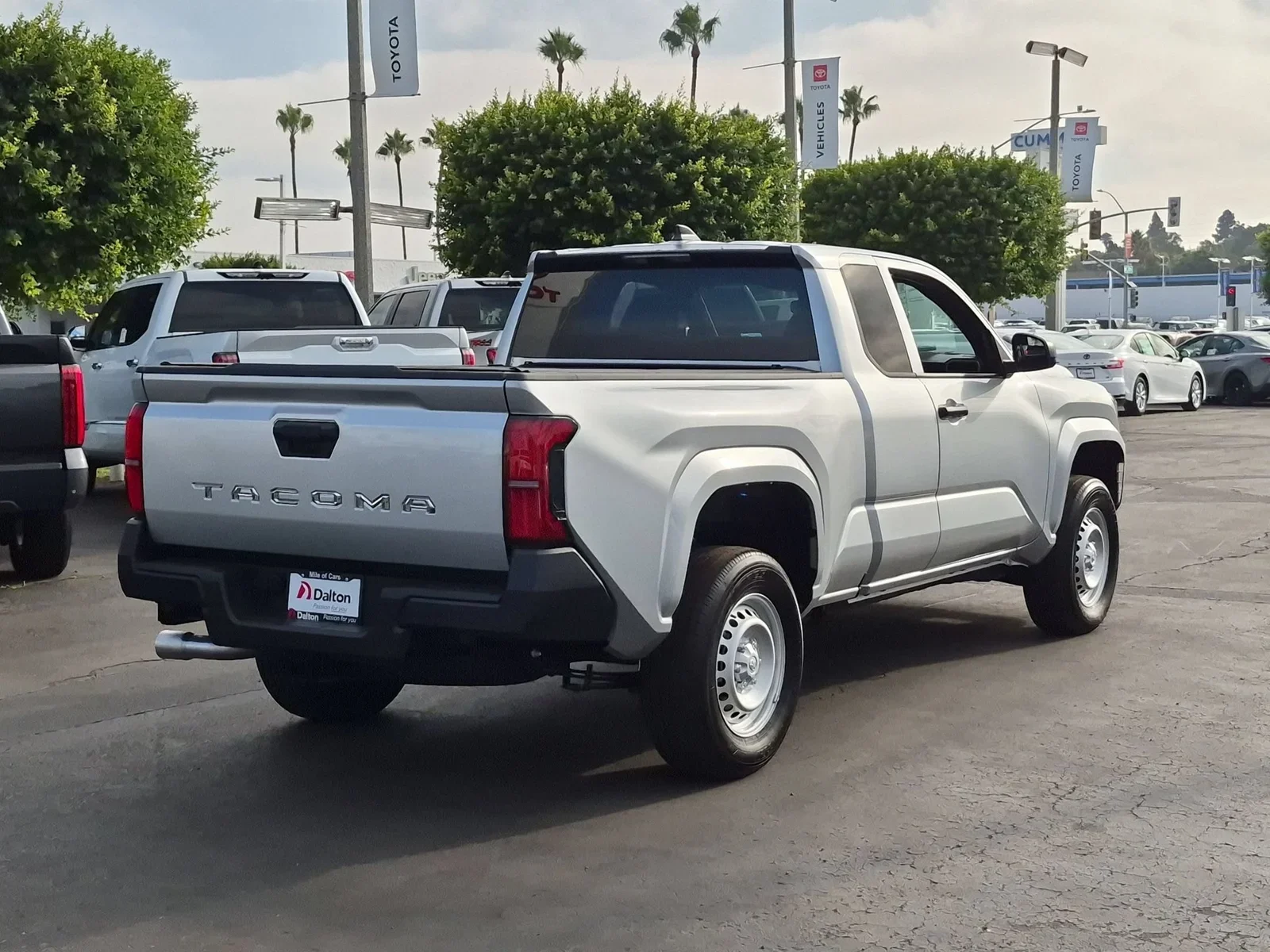 Rear three-quarter view of a silver 2026 Toyota Tacoma on the lot at Dalton Toyota National City