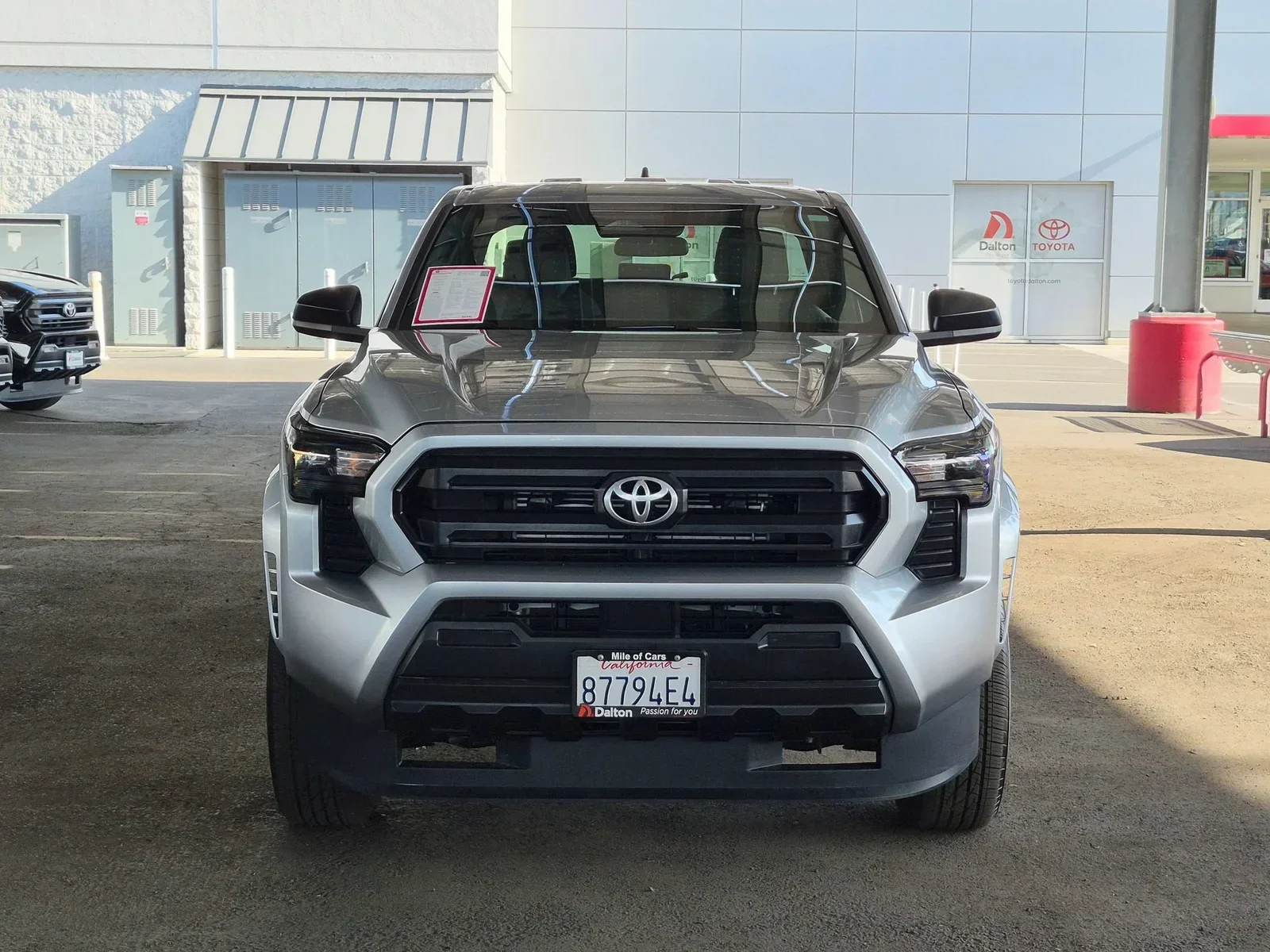 Front view of a silver Toyota Tacoma on the Dalton Toyota National City lot