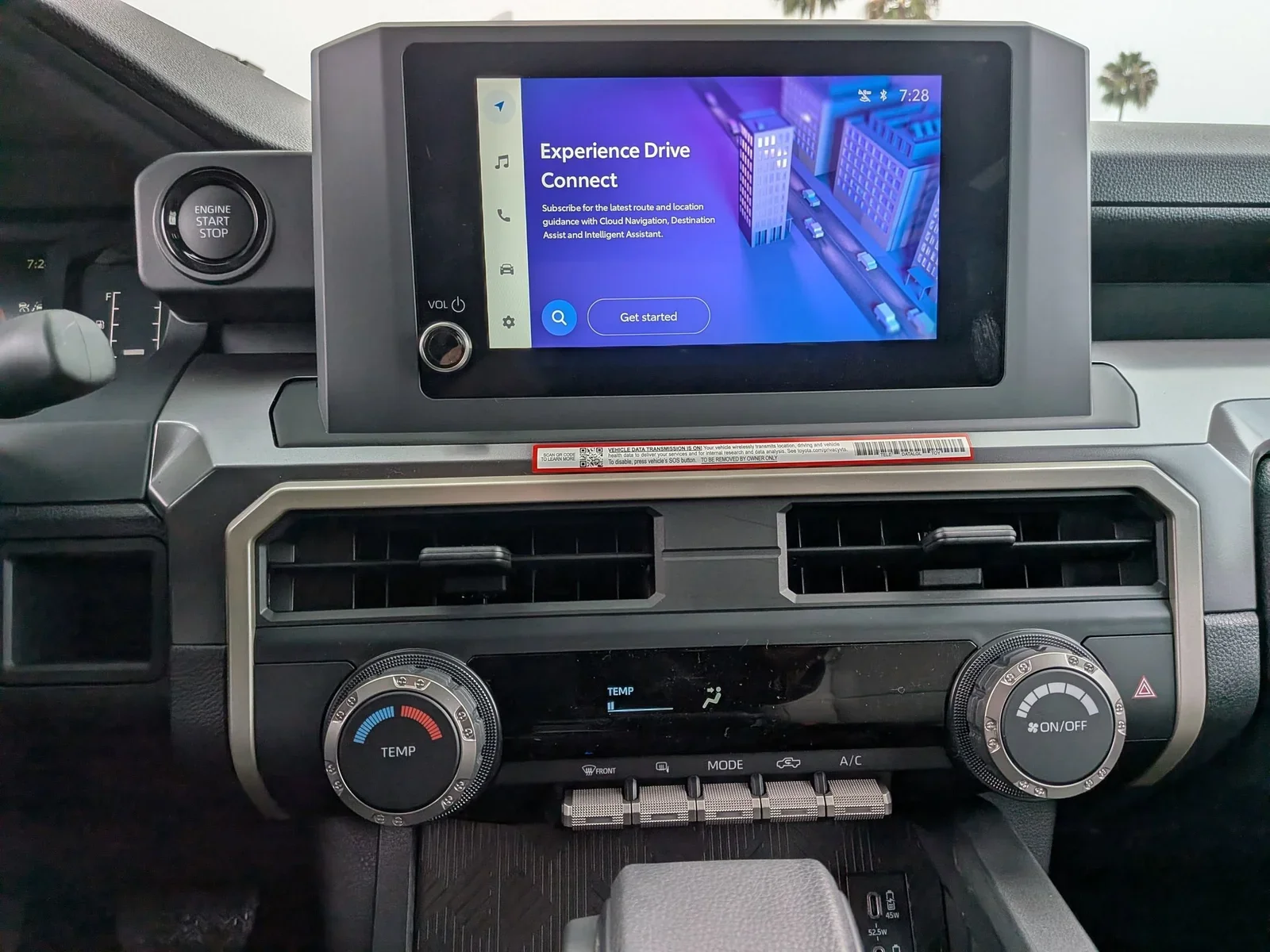 Close-up of the Toyota Tacoma center touchscreen with Drive Connect and climate dials