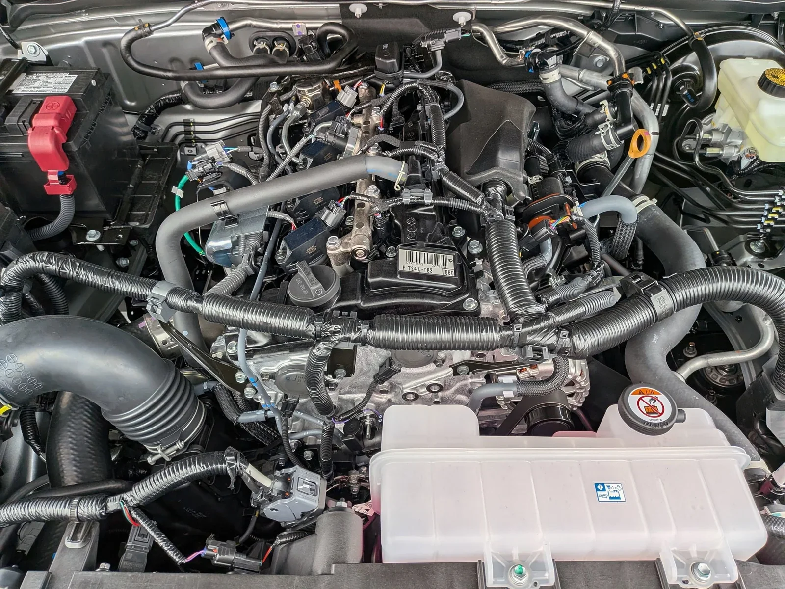 Engine bay of a Toyota Tacoma showing the i-FORCE 2.4-liter turbocharged four-cylinder