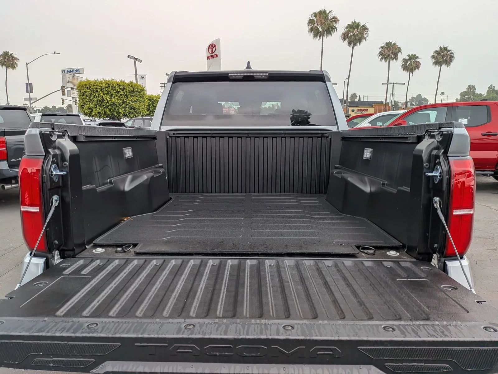 Tailgate down on a Toyota Tacoma showing the composite bed, on the Dalton Toyota lot