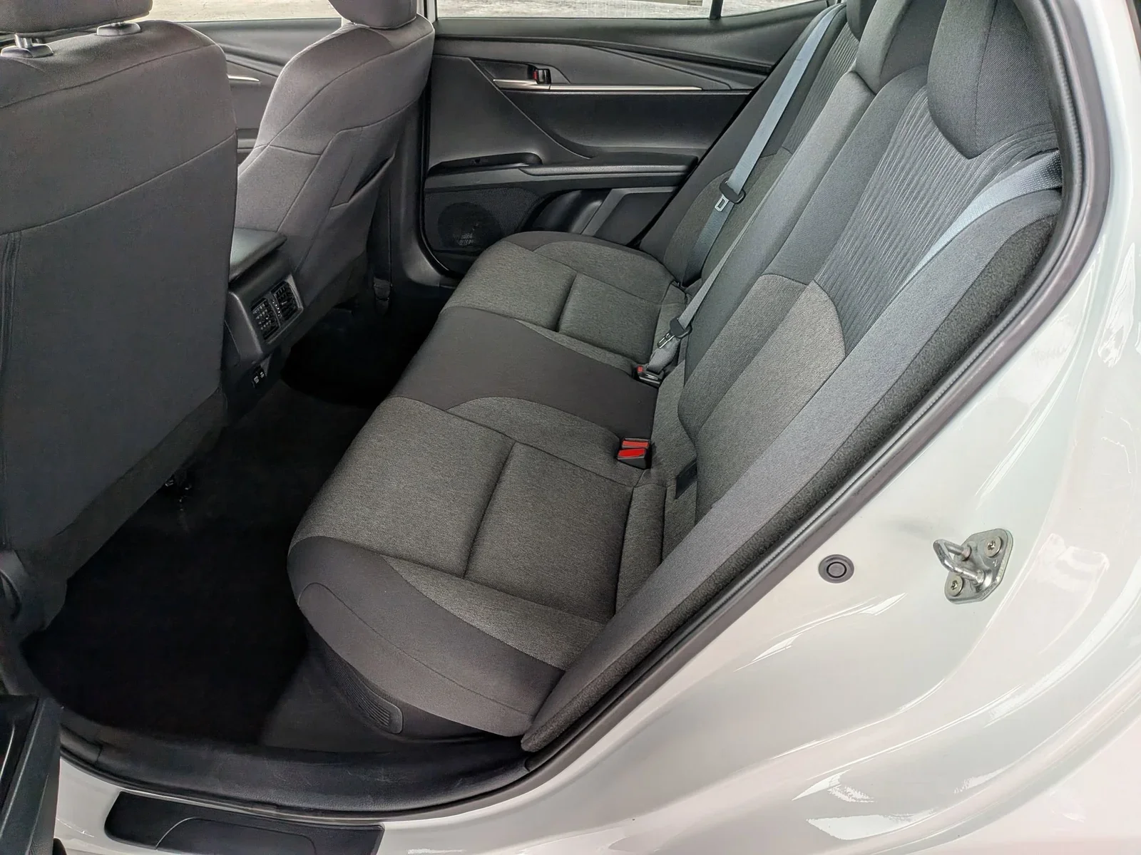 Rear seats of a used Toyota Camry with center armrest