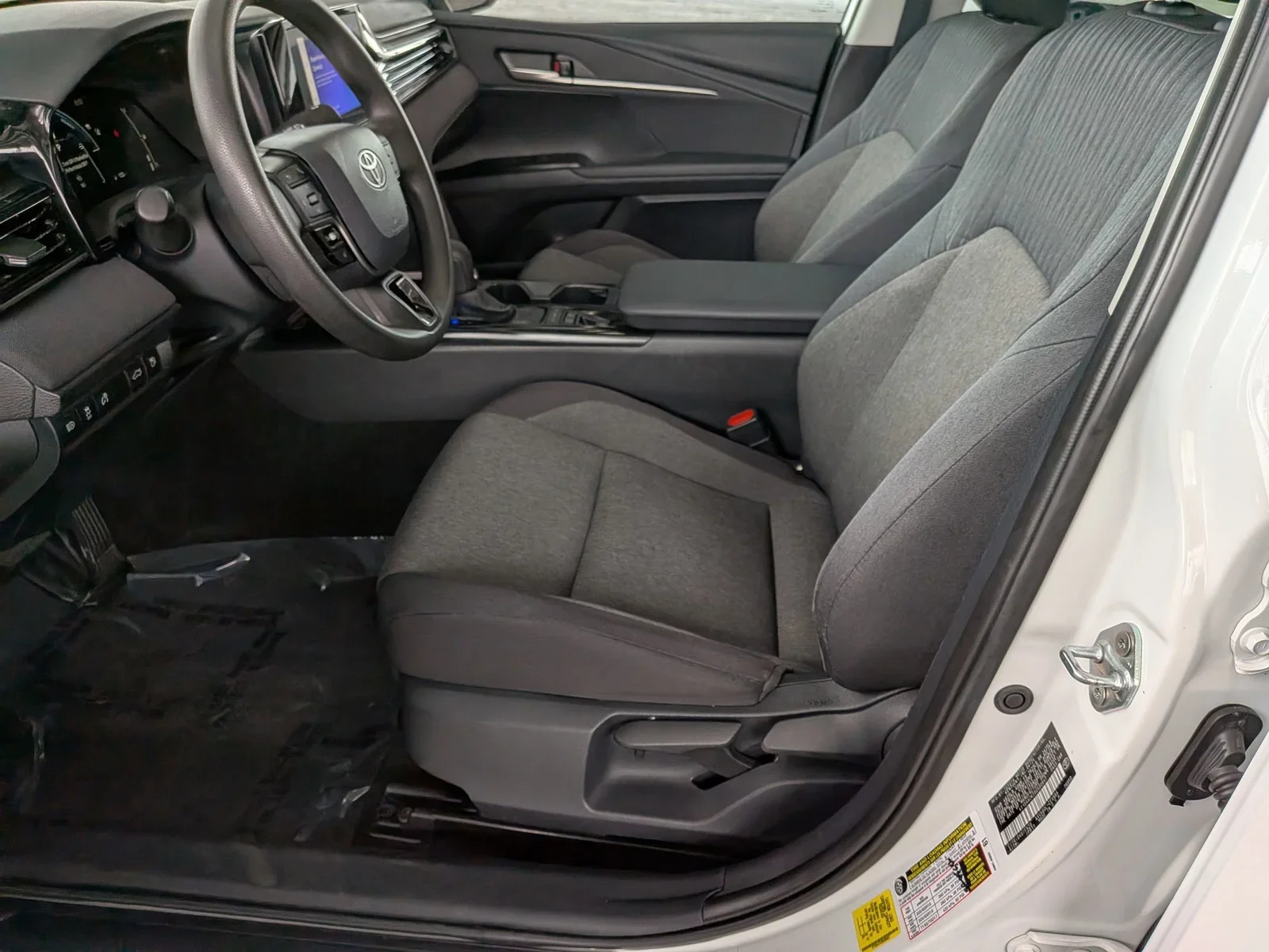 Front cloth seats and center console in a used Toyota Camry