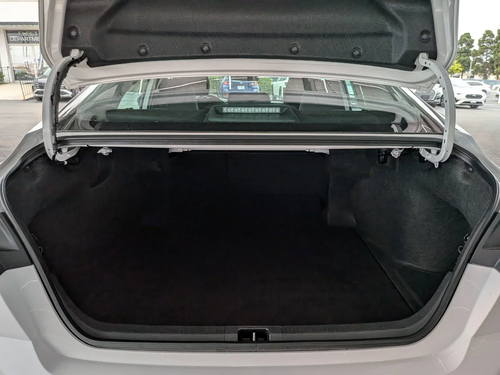 Open trunk of a used Toyota Camry showing the cargo area